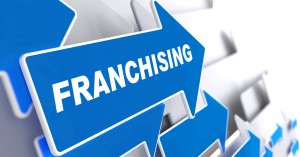 Franchising - Business Background. Blue Arrow with "Franchising" Slogan on a Grey Background. 3D Render.
